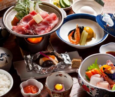 Assorted small Japanese dishes with rice and sashimi served at Hotel Izumi in Hokkaidō