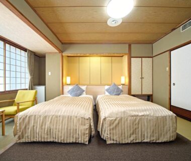 Twin beds in tatami-style room with shoji screens at Hotel Kameya, Miyagi Tohoku Japan