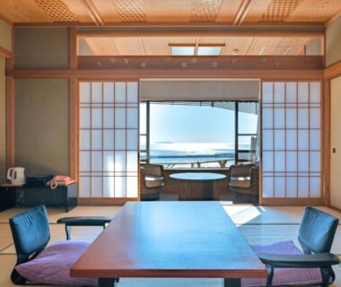 Tatami room with low table and shoji, balcony wooden bath at Hotel Kan-ichi in Shizuoka