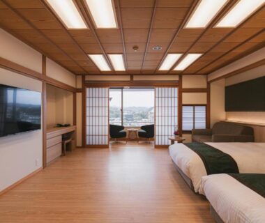 Twin beds, shoji screens and seating area opening to balcony in Hotel Kasuien, Saga, Kyushu