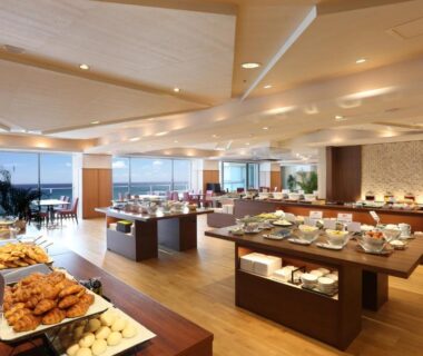 Buffet spread and seating at Hotel Kinparo with large windows and distant water view in Hyōgo, Kansai