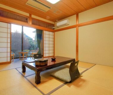 Tatami room with low table and shoji screens at Hotel Kinu in Tochigi, Kantō, Japan