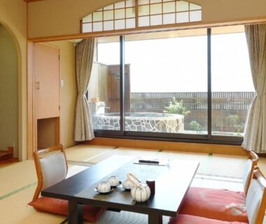 Tatami room with low table and balcony at Hotel Koryu in Yamanashi, Chūbu, Japan