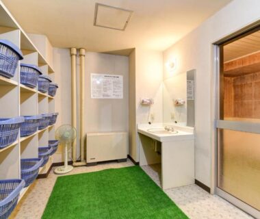 Changing area with blue baskets and sinks at Hotel La Montagne Furuhata, Nagano