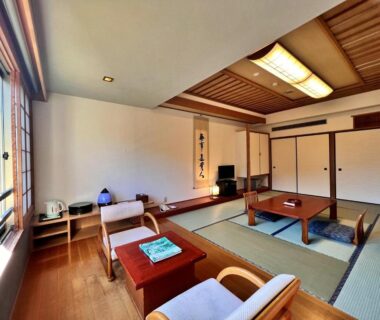 Traditional tatami room with low table, chairs, shoji doors and wooden ceiling at Hotel Miki, Gifu, Chūbu, Japan