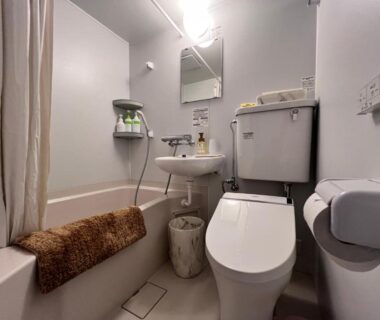 Compact bathroom with bathtub, toilet, sink and mirror at Hotel Miki in Gifu, Chubu, Japan