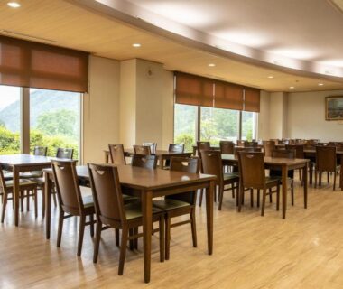 Dining area at Hotel Miki with wooden tables and mountain views in Chubu Gifu