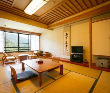 Tatami room with low table, shoji window and tokonoma at Hotel Miki in Chūbu, Gifu, Japan