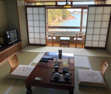 Traditional tatami room at Hotel Nagisaya with low table, shoji screens and balcony overlooking Wakayama coast