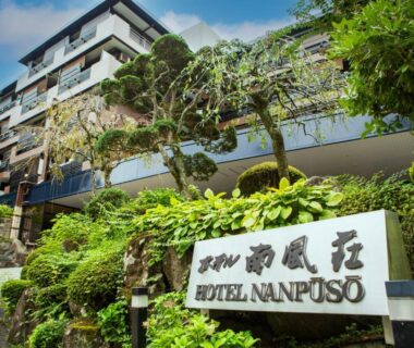 Entrance sign and stair path leading to Hotel Nanpuso with landscaped greenery in Kanagawa