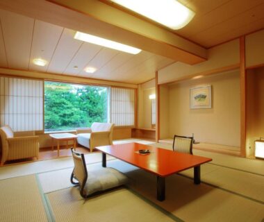 Tatami room with low table, seating area and garden view at Hotel New Mitoya in Miyagi, Tohoku