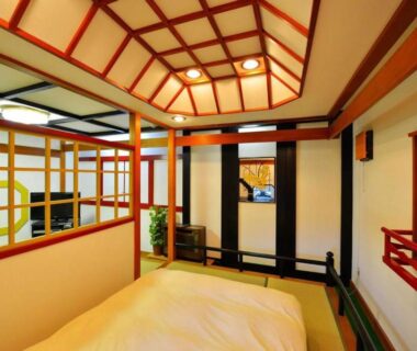 Tatami room with futon, shoji screens and wooden lattice ceiling at Hotel New Otani, Chiba