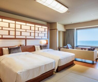 Twin beds and tatami seating area at Hotel Oosado, Niigata, Chūbu, Japan