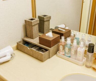 Countertop toiletries and hair dryer at Hotel Oosado bathroom in Niigata, Chūbu, Japan