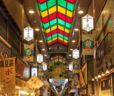Colorful covered market arcade with stained glass skylight and traditional shop signs in Kyoto shopping district