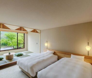 Twin beds and tatami seating with garden view at Hotel Park in Chūbu, Gifu, Japan