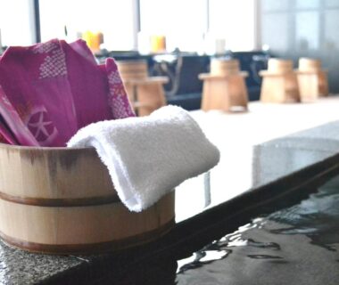 Wooden bath bucket and towel beside indoor onsen at Hotel Resorpia Atami in Shizuoka, Chūbu