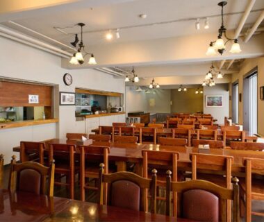 Wooden dining room with rows of tables at Hotel ST MORITZ in Niigata, Chūbu