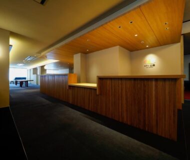 Wood reception counter and seating area in Hotel Sanraku lobby, Nagano