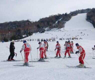 Group of skiers on snowy slope near Hotel Sanraku in Nagano, Chūbu region, Japan