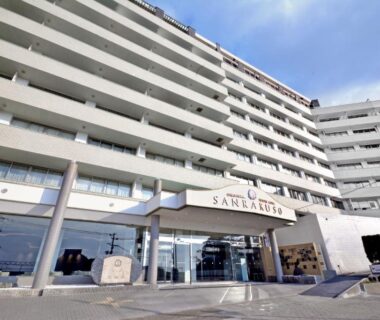 Multi-story hotel facade with glass entrance and canopy at Hotel Sanrakuso in Wakayama