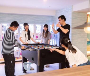 Guests playing foosball in communal lounge at Hotel Sanrakuso in Wakayama, Kansai, Japan