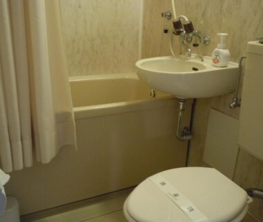 Small bathtub, sink and toilet in compact bathroom at Hotel Seikoen, Tochigi, Kantō Japan