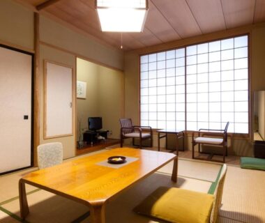 Traditional tatami room with low wooden table, zabuton cushions and shoji screens at Hotel Seikoen in Tochigi, Kantō