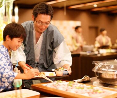 Family in yukata selecting dishes at Hotel Senshukaku buffet in Iwate, Tohoku