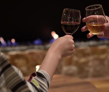 Two hands clinking wine glasses at Hotel Shidotaira in Iwate Japan