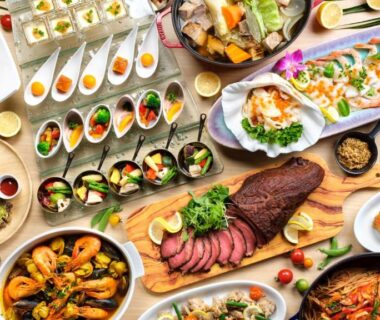 Variety of plated Japanese dishes and shared platters on a dining table at a ryokan