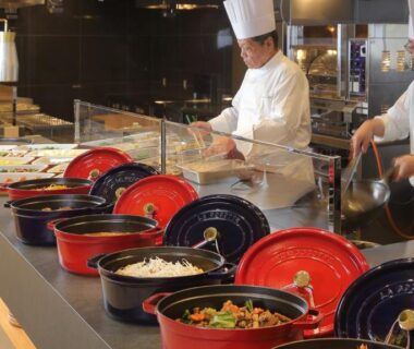 Chefs in white uniforms at buffet counter with colorful lidded serving bowls, Hotel Shidotaira, Iwate