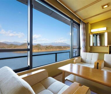 Seating area with large window facing lake and mountains, Hotel Shion, Iwate Japan