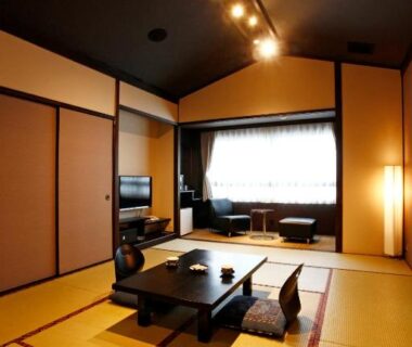 Traditional tatami room with low table, floor cushions and window seating at Hotel Shosenkaku Romankan in Kumamoto, Kyushu