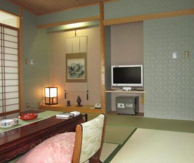 Traditional tatami room with low table, shoji screens and tokonoma at Hotel Spax Kusatsu in Gunma