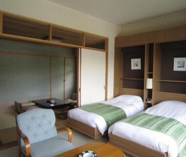 Twin beds and tatami seating area with shoji screens at Hotel Spax Kusatsu, Gunma, Japan
