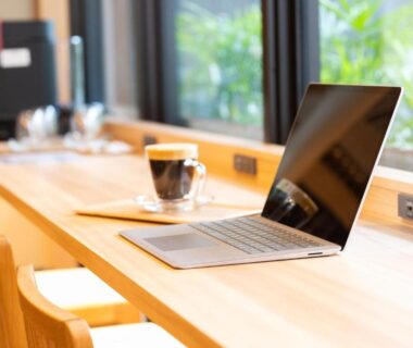 Laptop and coffee on wooden counter by window at Hotel Sugicho in Kyoto, Kansai