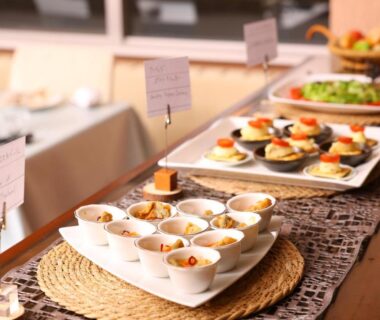 Assorted small dishes and appetizers arranged on a buffet table in Hotel Takimoto dining area, Nagano