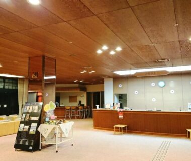 Warm reception area with wooden ceiling, sofas and brochure stand at Hotel Tetoraresort Tokachigawa, Hokkaidō