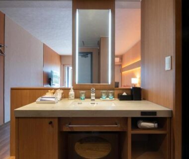 Bathroom vanity with mirror and wooden stool at Hotel Tokinoza, Mie, Kansai, Japan