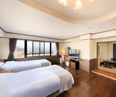 Twin beds with tatami seating area at Hotel Tsubakino Nagano Chūbu