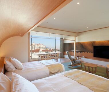 Twin beds and seating area overlooking city from Hotel Wakamizu, Hyōgo, Kansai, Japan