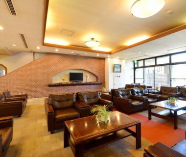 Leather sofas and wooden coffee tables in lounge at Hotel Wellness Notoji, Chūbu, Ishikawa
