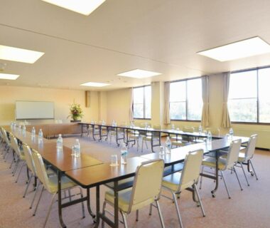 Meeting room with U-shaped tables and chairs at Hotel Wellness Notoji in Chūbu, Ishikawa