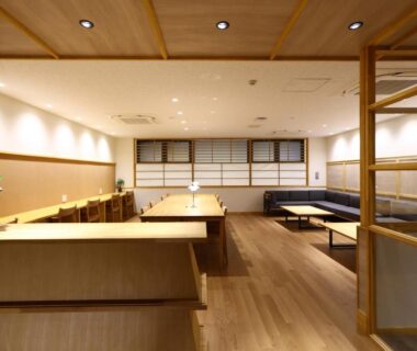 Wood-paneled dining lounge with low tables and bench seating, Hotel Yudanaka, Nagano, Chūbu Japan