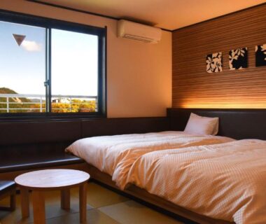 Tatami room with twin beds and window view at Hotel Yume-no-yu Nagano