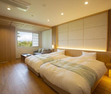 Western-style twin bedroom with wooden flooring, shoji screens and seating area at Hotel Yumeshizuku, Kumamoto, Kyushu
