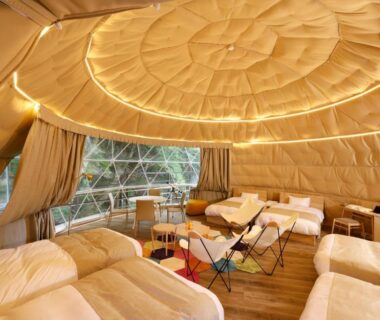 Spacious glamping tent with multiple beds at Hotel&Glamp YAMABOSHI Nagano