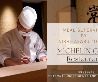 Chef in white uniform preparing food behind a wooden counter with restaurant signage at Hotel&Glamp YAMABOSHI, Nagano, Chūbu