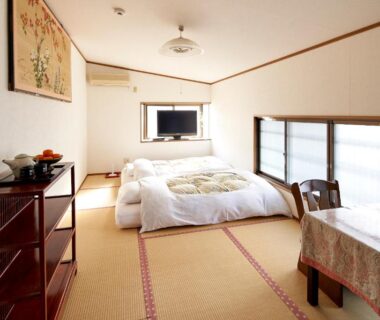 Tatami room with futon, low table and shoji screens at Hotobil B&B 潤 in Nara, Kansai